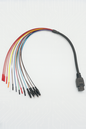 breakout cable with a black connector on the right and multiple multicolored wires fanned out to the left, ending in alligator clips and pin connectors, displayed against a light gray circuit board patterned background